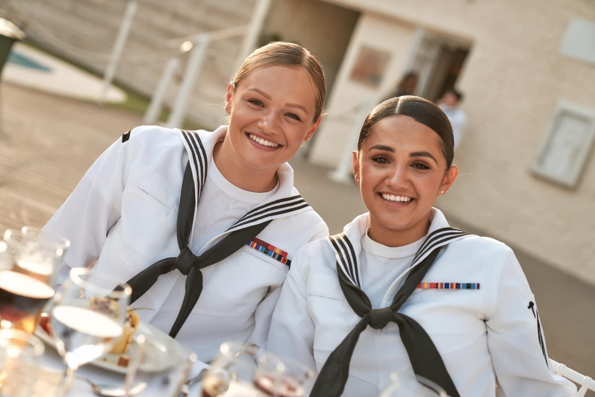 Gary's daughter smiles in uniform with a fellow sailor